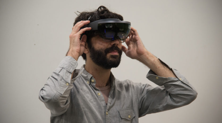 Faculty Casey Anderson tries on the Microsoft Hololens